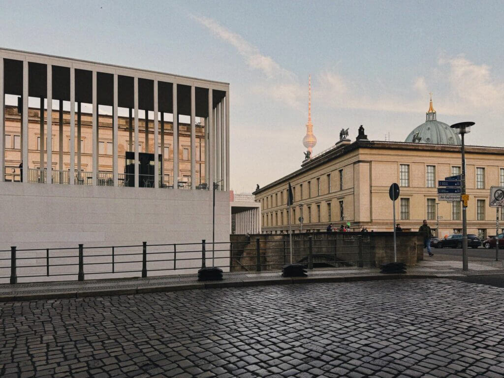 Modern and classic Berlin architecture featuring the iconic Fernsehturm under a clear sky.