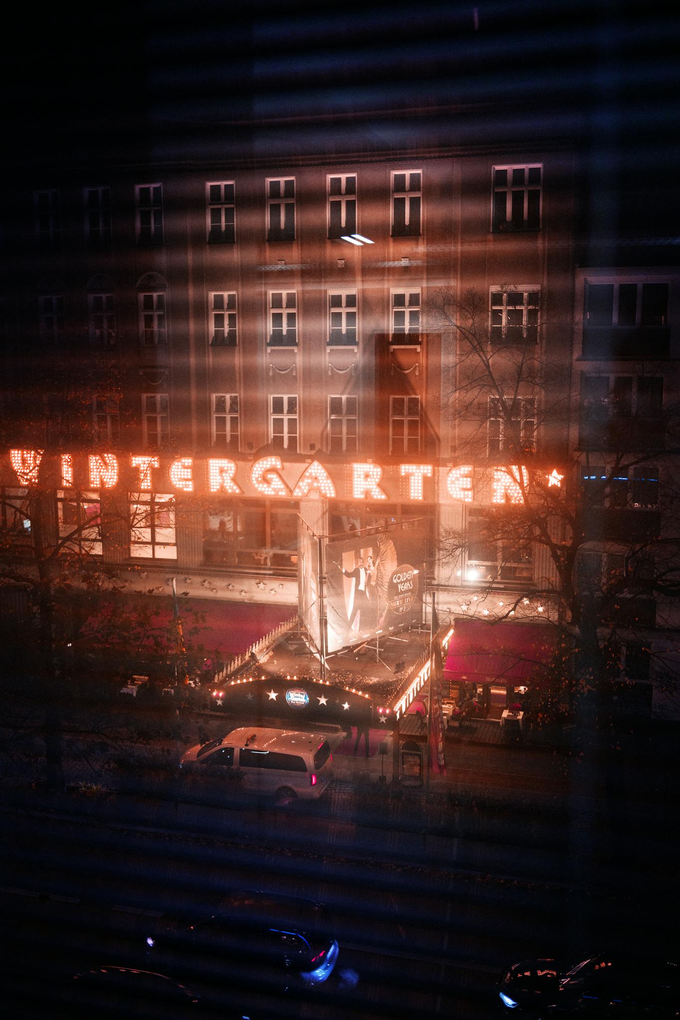 Night view of the iconic Wintergarten Theater in Berlin, beautifully illuminated and vibrant.